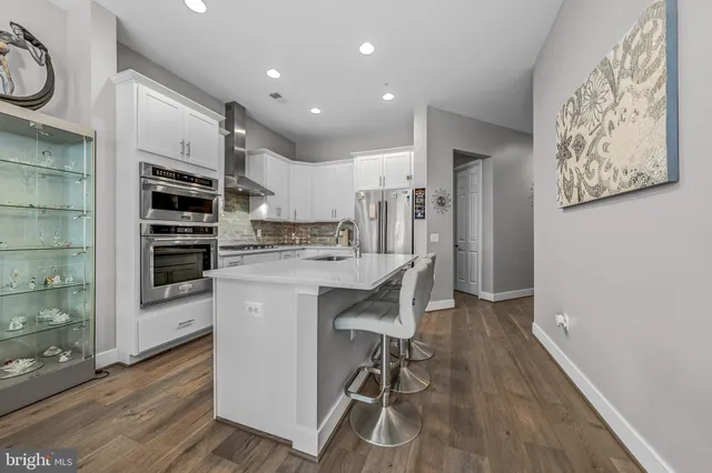 a kitchen with stainless steel appliances a stove a refrigerator and a microwave