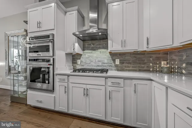 a kitchen with stainless steel appliances granite countertop a sink and a stove