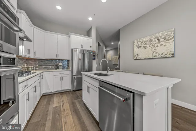 a kitchen with a sink appliances and cabinets