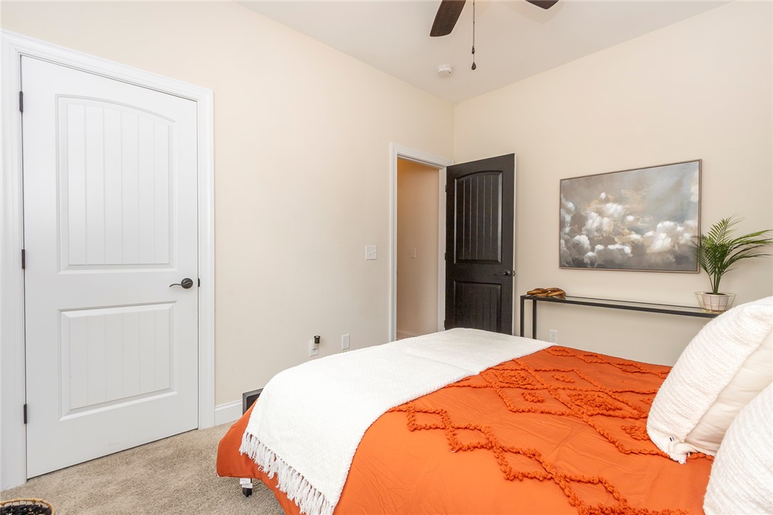 234 Streams Way Anderson, SC 29625 - Photo 22 of 44 This cozy bedroom offers a tranquil retreat with soft carpet and a convenient ceiling fan.