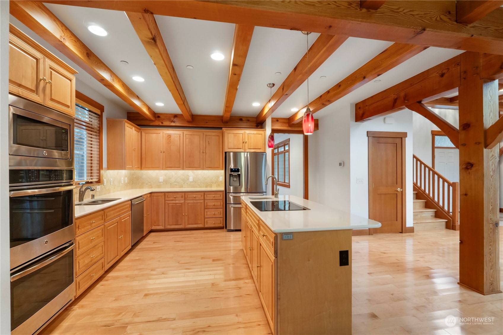 73 Raft Island Drive Northwest Gig Harbor, WA 98335 - Photo 12 of 40 a large white kitchen with stainless steel appliances kitchen island granite countertop a large counter top and stove