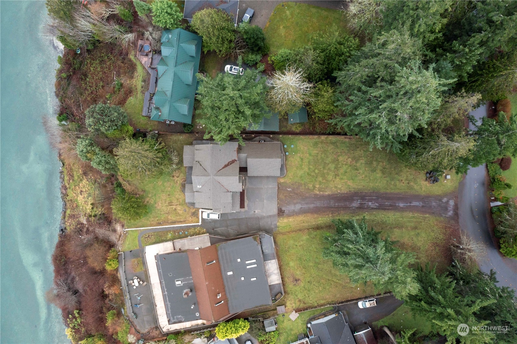 73 Raft Island Drive Northwest Gig Harbor, WA 98335 - Photo 3 of 40 an aerial view of a house with a garden and lake view