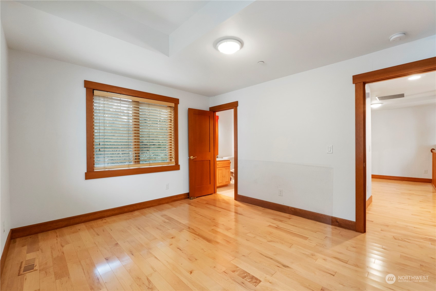 73 Raft Island Drive Northwest Gig Harbor, WA 98335 - Photo 32 of 40 a view of an empty room with wooden floor and a window
