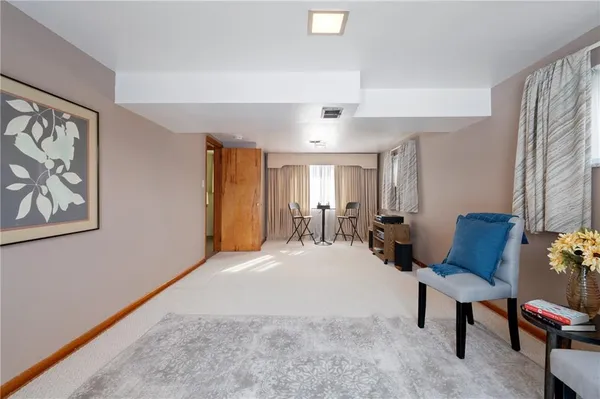 a living room with furniture a window and a flat screen tv