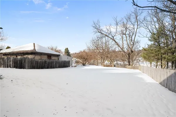 a backyard of a house with large trees