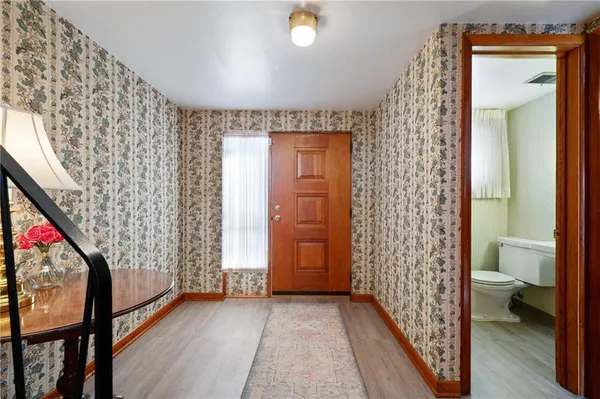 a view of entryway with wooden floor and door