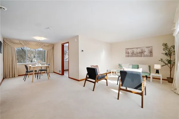 a view of a livingroom with furniture and a window