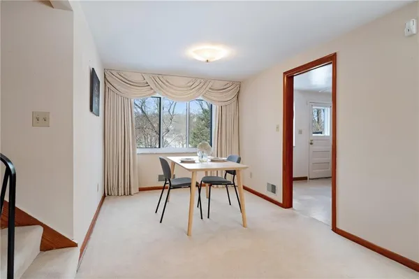 a dining room with furniture and window