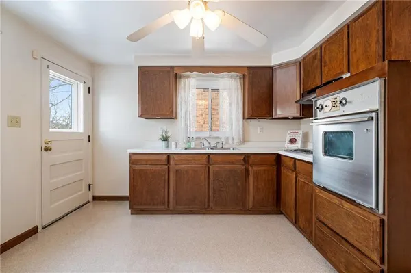 a kitchen with cabinets a sink and appliances