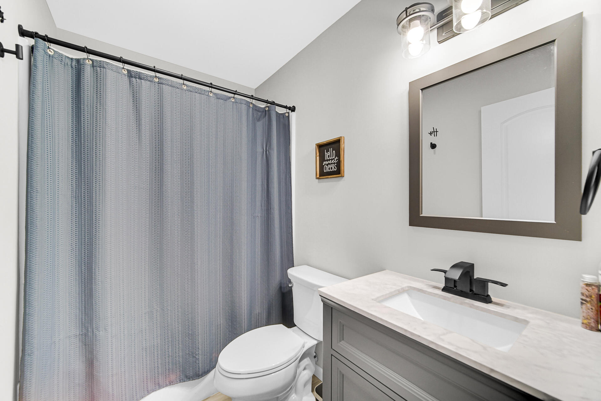110 Beech Court Hebron, IN 46341 - Photo 14 of 18 a bathroom with a sink a toilet and shower curtain