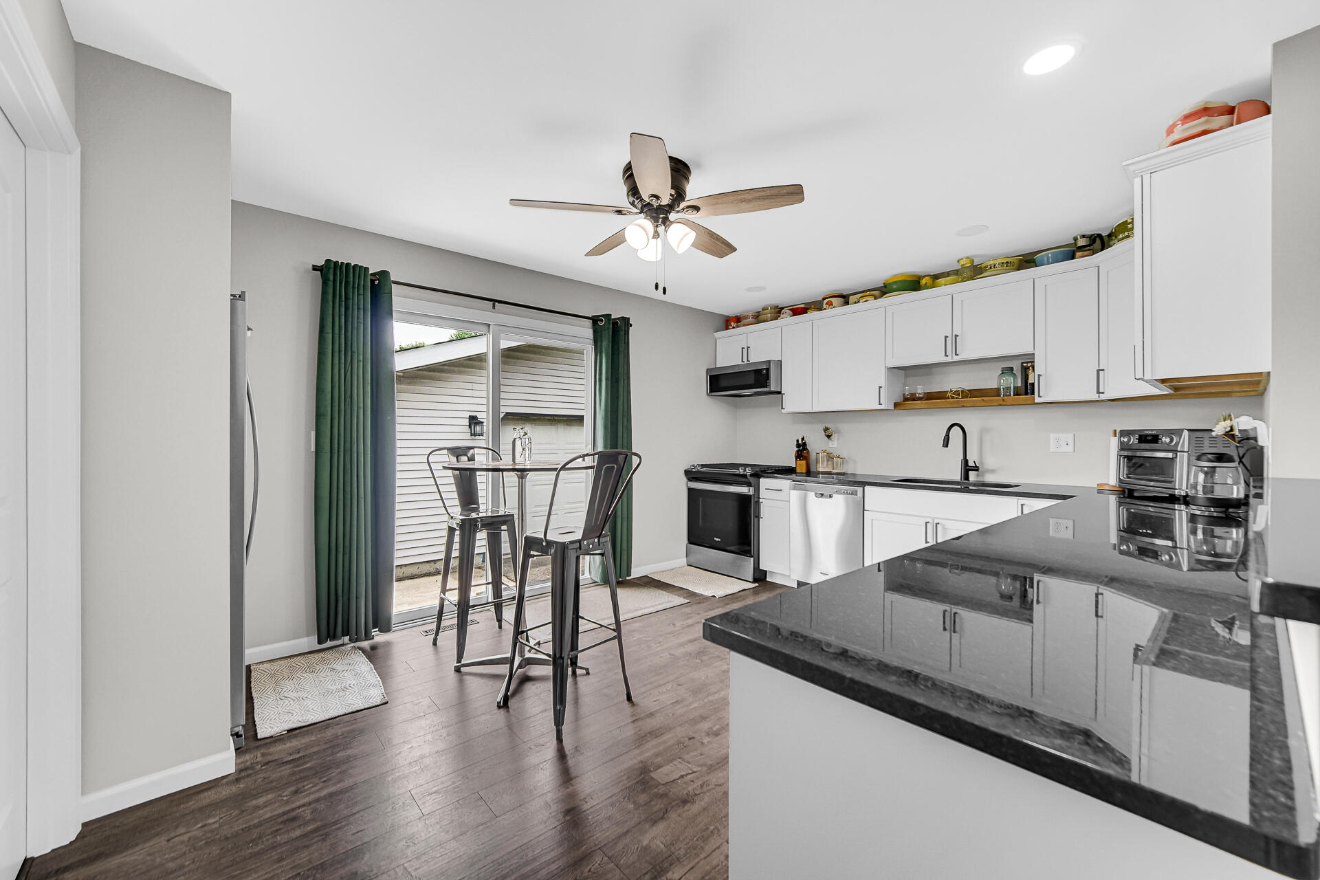 110 Beech Court Hebron, IN 46341 - Photo 6 of 18 a kitchen with granite countertop a stove a sink and a refrigerator