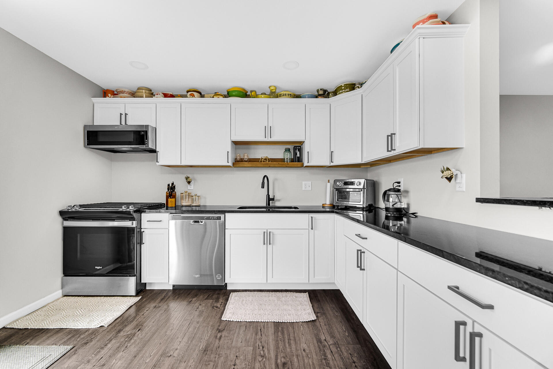 110 Beech Court Hebron, IN 46341 - Photo 7 of 18 a kitchen with granite countertop white cabinets and white appliances