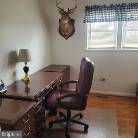 a work room with furniture and a window