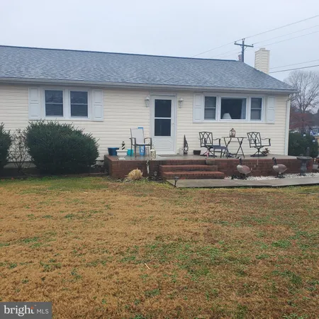 a front view of house with yard and seating space