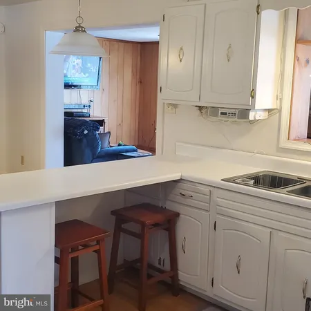 a kitchen with cabinets appliances and a window