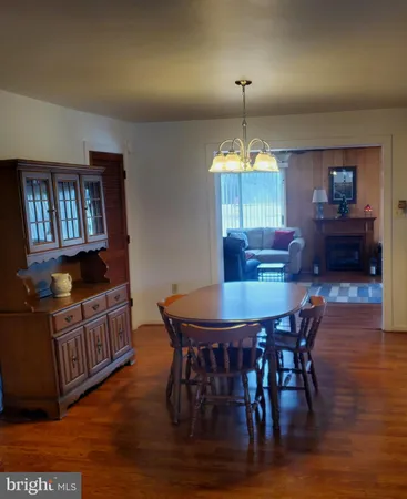 a dining room with furniture and wooden floor