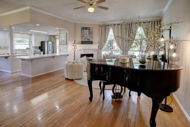 a large kitchen with stainless steel appliances granite countertop a stove a sink a dining table and chairs