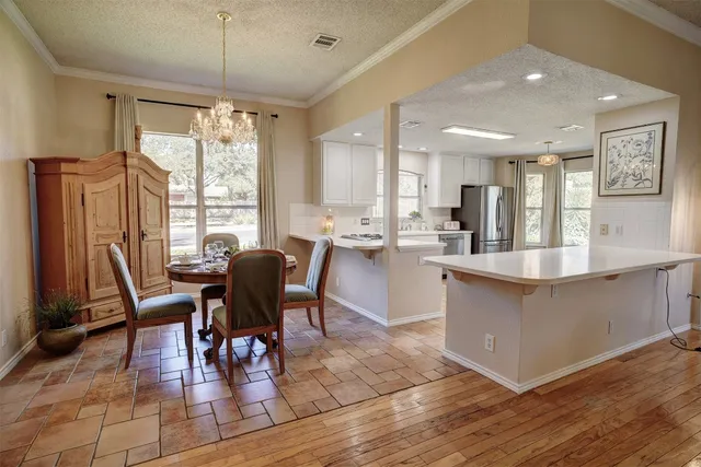 a large kitchen with stainless steel appliances kitchen island granite countertop a sink and cabinets