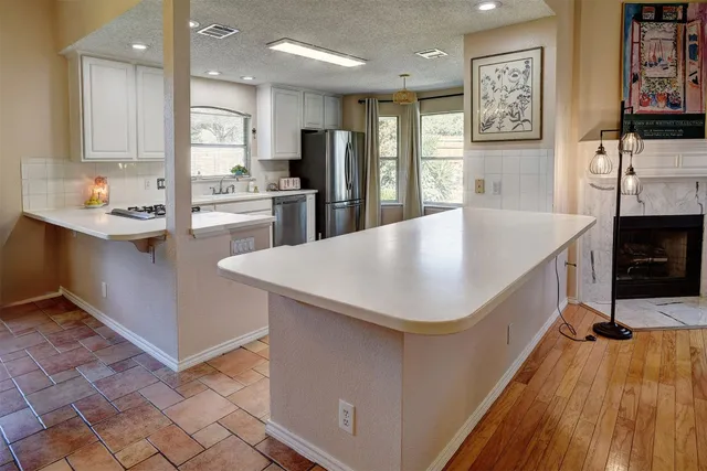 a kitchen with stainless steel appliances a refrigerator sink and cabinets