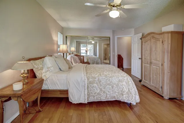 a bedroom with a large bed and a chandelier