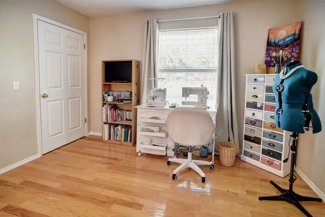 a view of a livingroom with workspace and a window