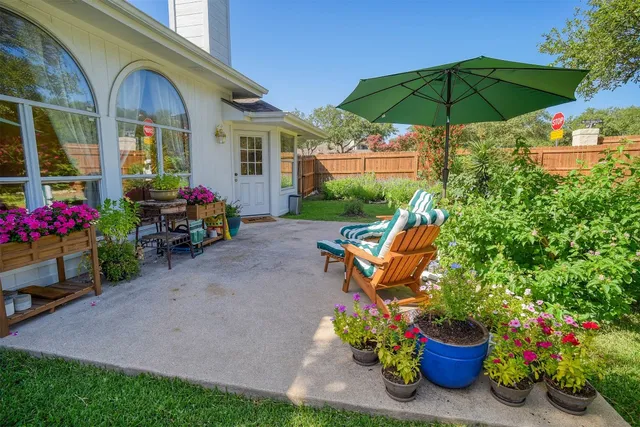 a view of a house with backyard sitting area and garden