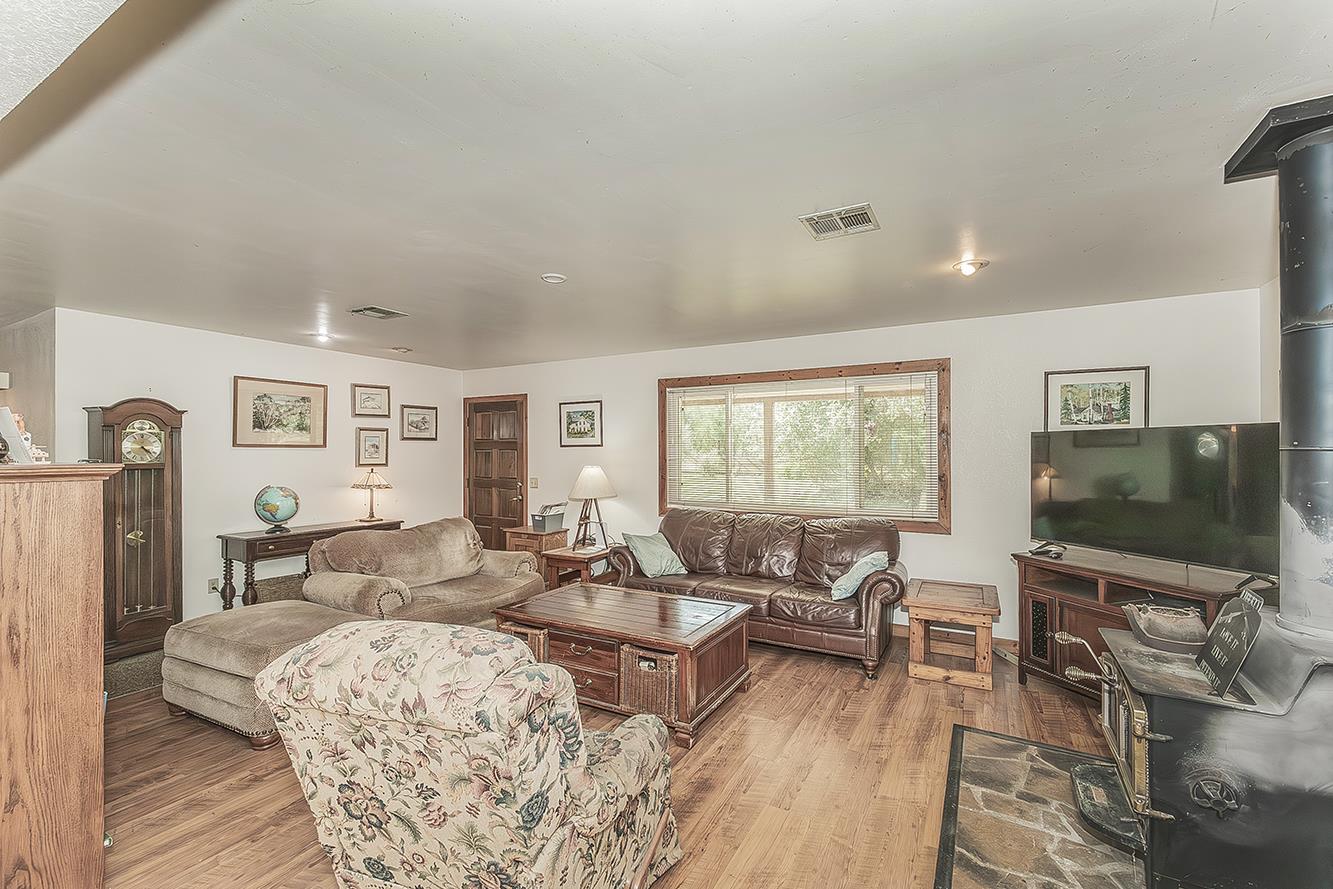 26045 Pittman Hill Road Clovis, CA 93619 - Photo 16 of 93 a living room with furniture a flat screen tv and a floor to ceiling window