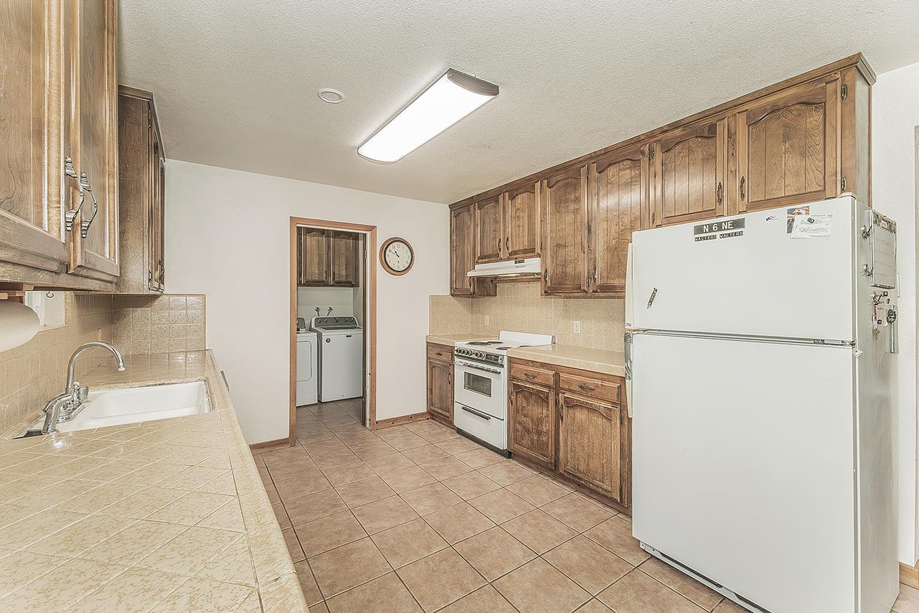 26045 Pittman Hill Road Clovis, CA 93619 - Photo 20 of 93 a kitchen with stainless steel appliances a refrigerator sink and cabinets