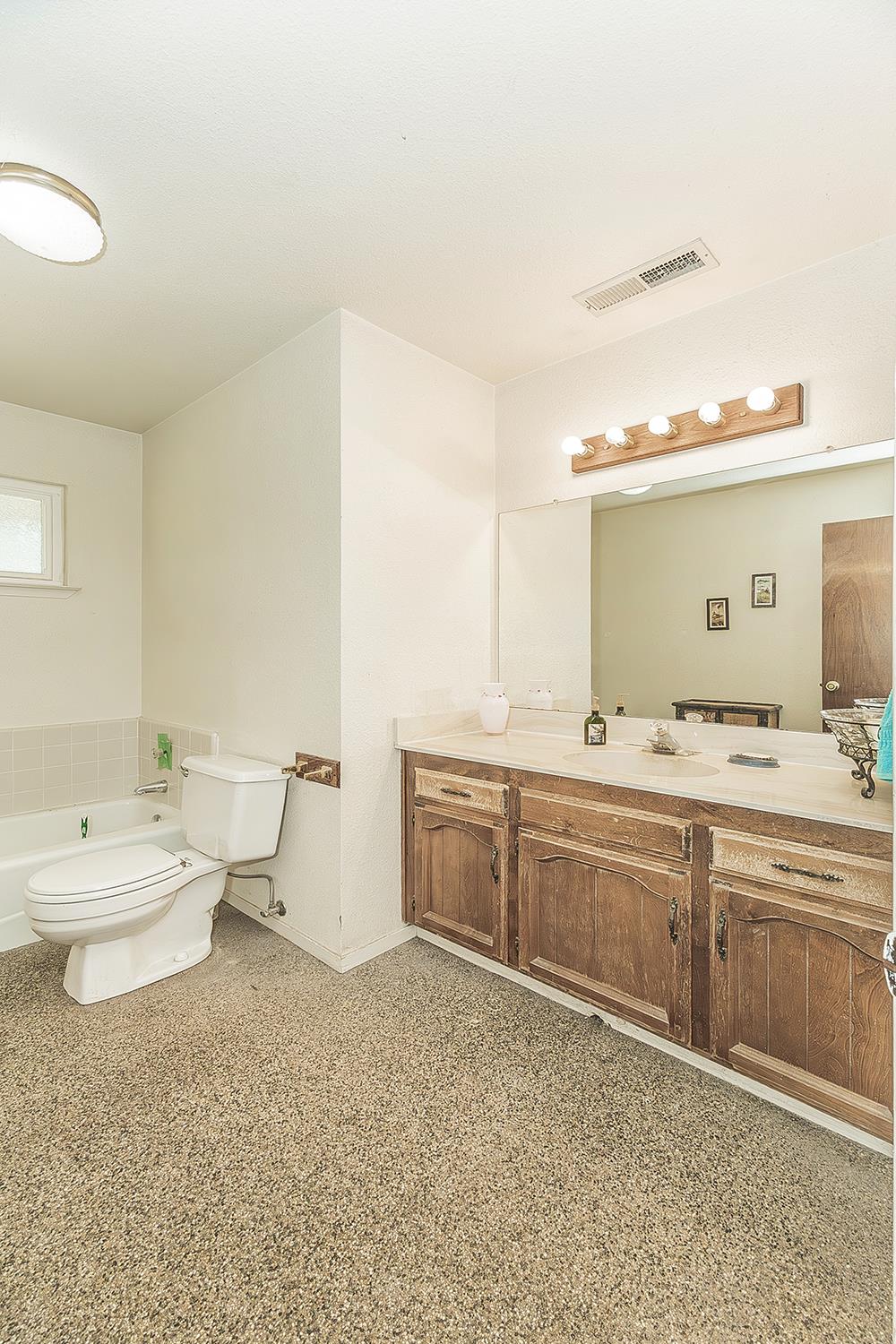 26045 Pittman Hill Road Clovis, CA 93619 - Photo 27 of 93 a bathroom with a double vanity sink mirror and toilet
