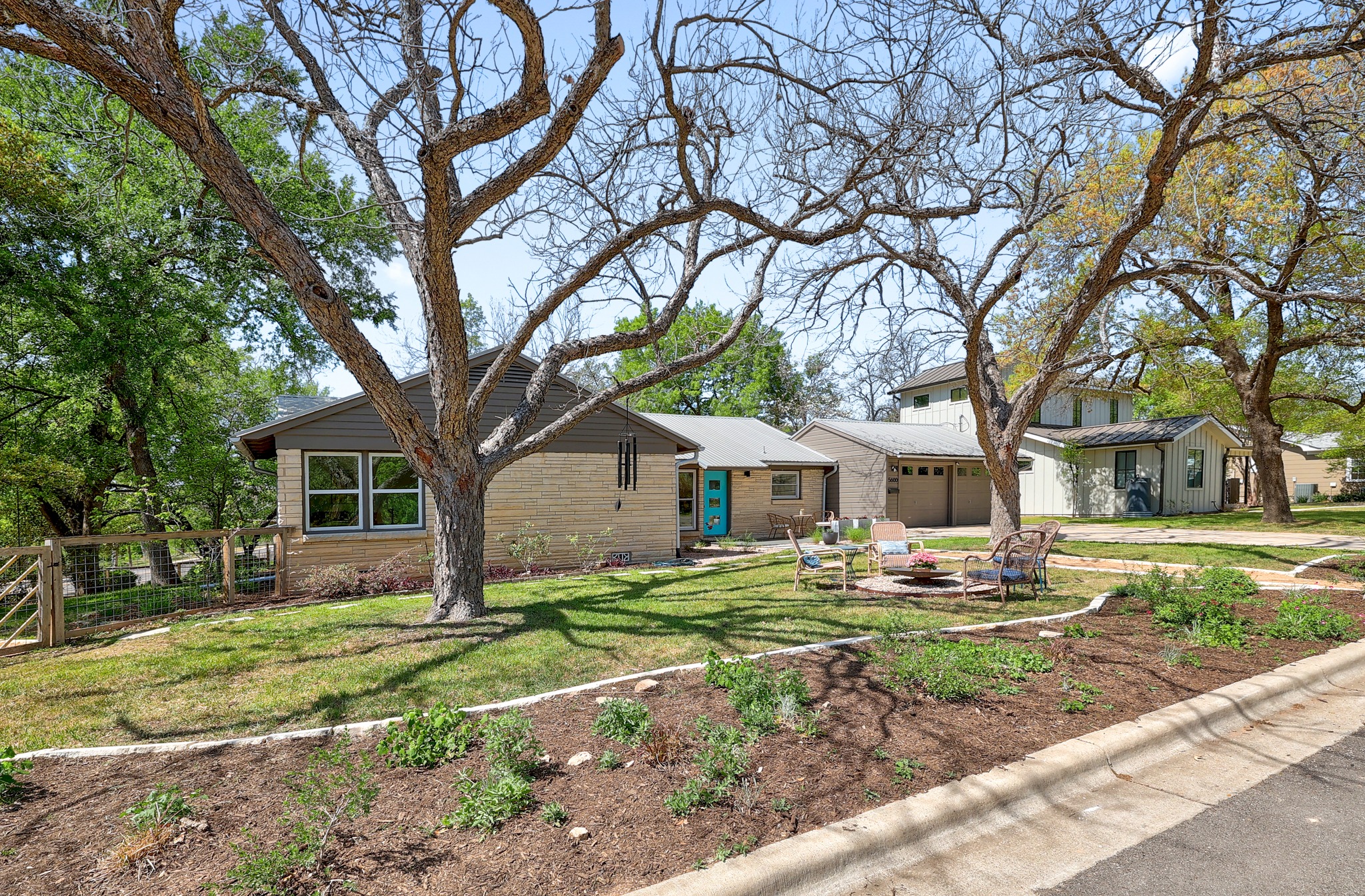 5600 Bull Creek Road Austin, TX 78756 - Photo 2 of 33 a front view of a house with garden