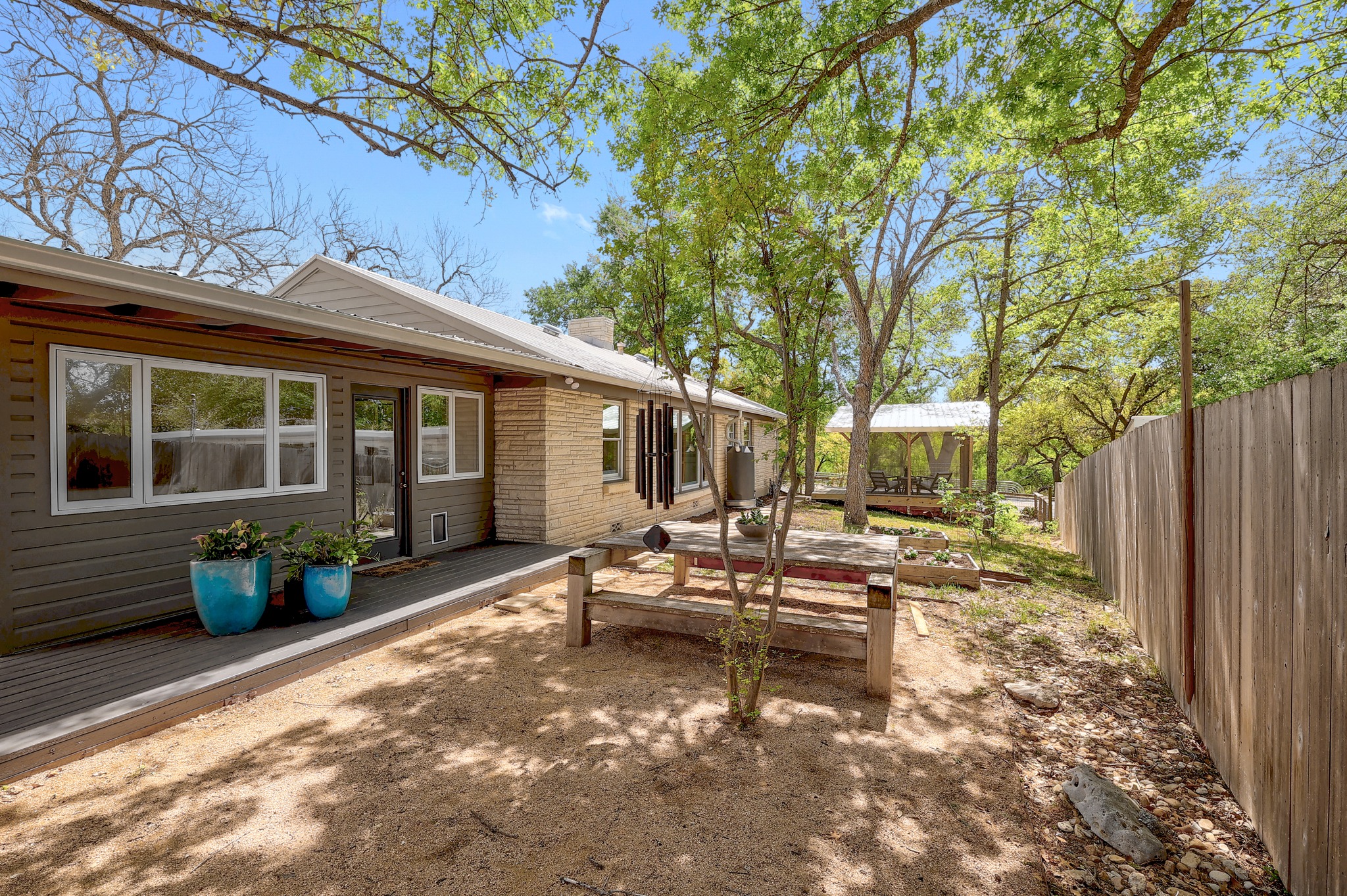 5600 Bull Creek Road Austin, TX 78756 - Photo 22 of 33 a view of a house with backyard sitting area and garden