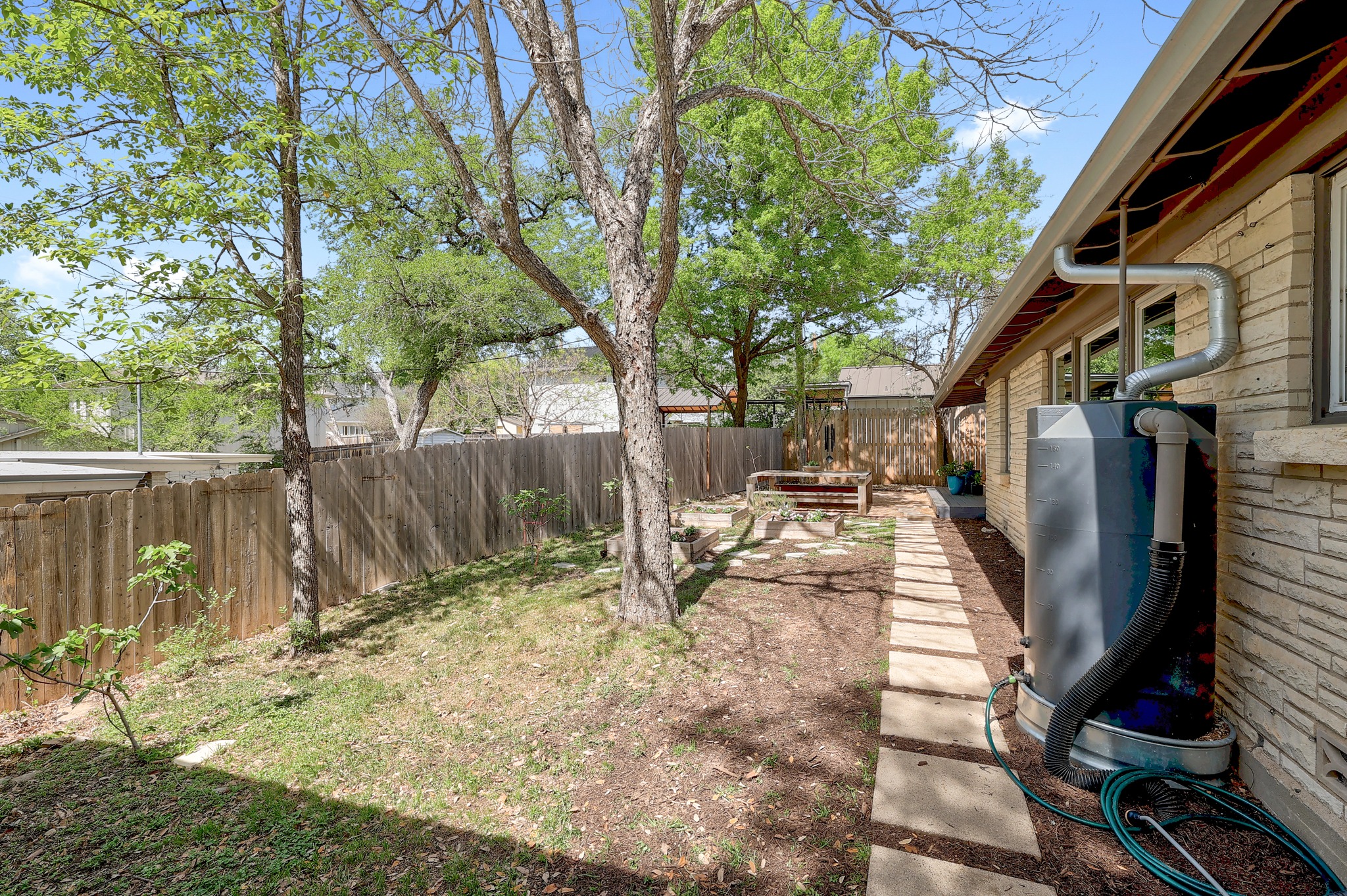 5600 Bull Creek Road Austin, TX 78756 - Photo 23 of 33 a view of backyard with wooden fence and large trees