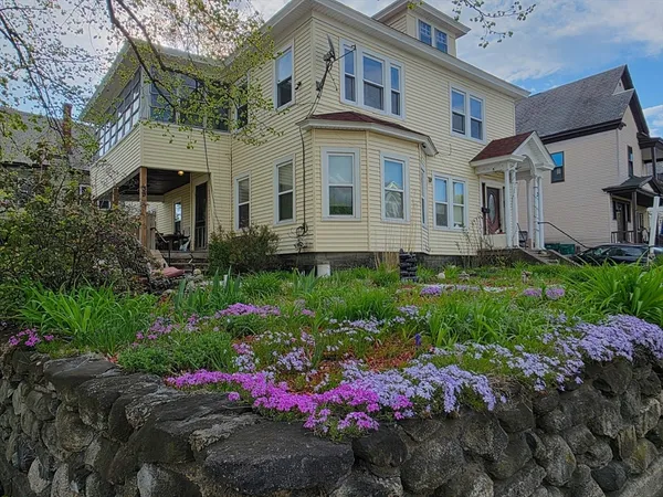 a view of a house with a yard and plants