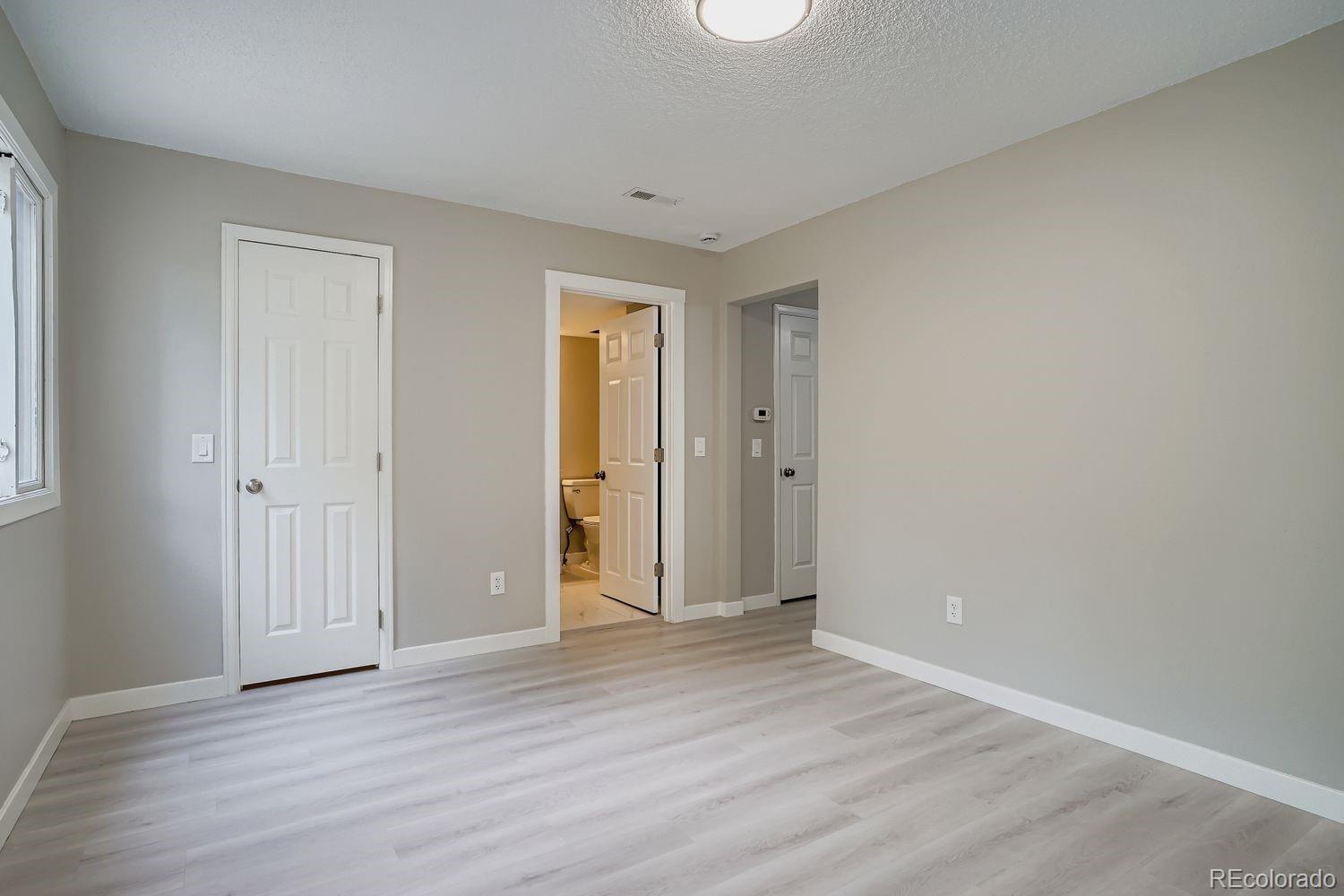 3050 West 32nd Avenue, Unit 102C Denver, CO 80211 - Photo 14 of 36 a view of an empty room with wooden floor and closet