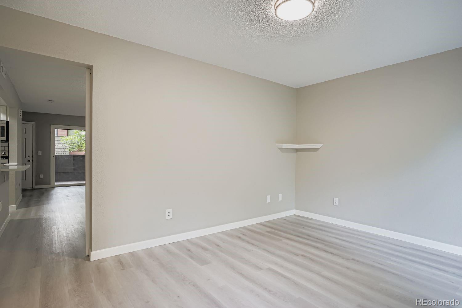 3050 West 32nd Avenue, Unit 102C Denver, CO 80211 - Photo 16 of 36 wooden floor in an empty room