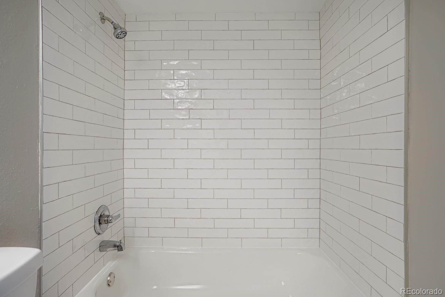 3050 West 32nd Avenue, Unit 102C Denver, CO 80211 - Photo 17 of 36 a bathroom with a bathtub