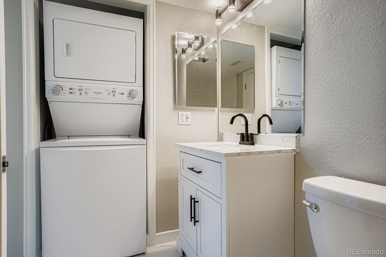 3050 West 32nd Avenue, Unit 102C Denver, CO 80211 - Photo 18 of 36 a bathroom with a toilet sink and mirror