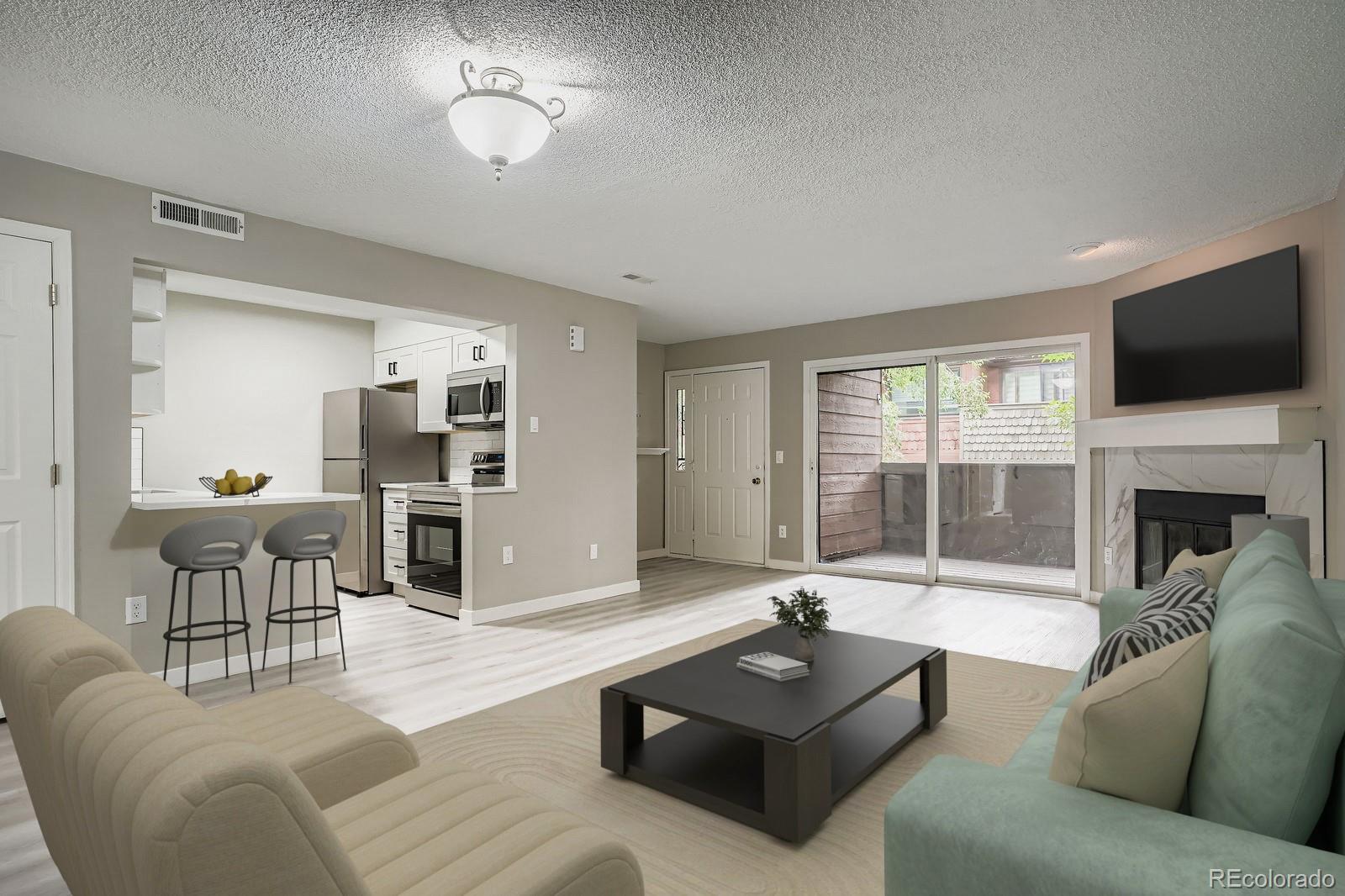 3050 West 32nd Avenue, Unit 102C Denver, CO 80211 - Photo 2 of 36 a living room with furniture a fireplace and a flat screen tv