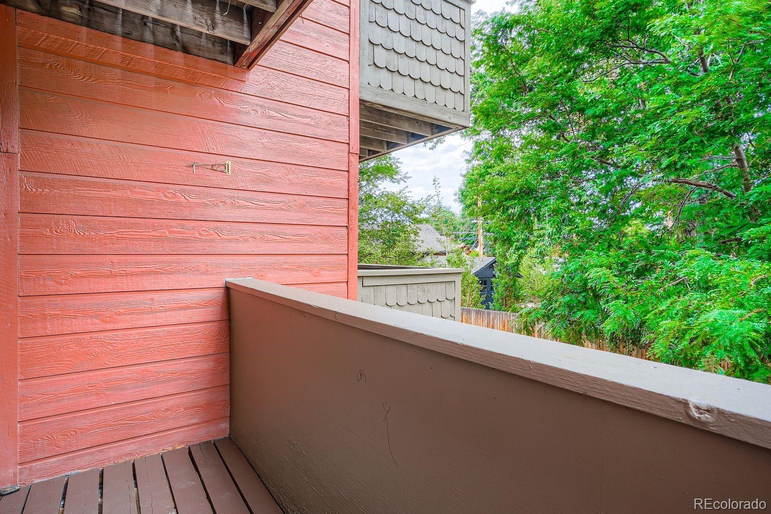 3050 West 32nd Avenue, Unit 102C Denver, CO 80211 - Photo 23 of 36 a view of balcony with wooden floor and fence