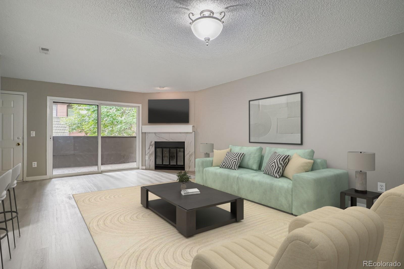 3050 West 32nd Avenue, Unit 102C Denver, CO 80211 - Photo 4 of 36 a living room with couches a fireplace and a large window