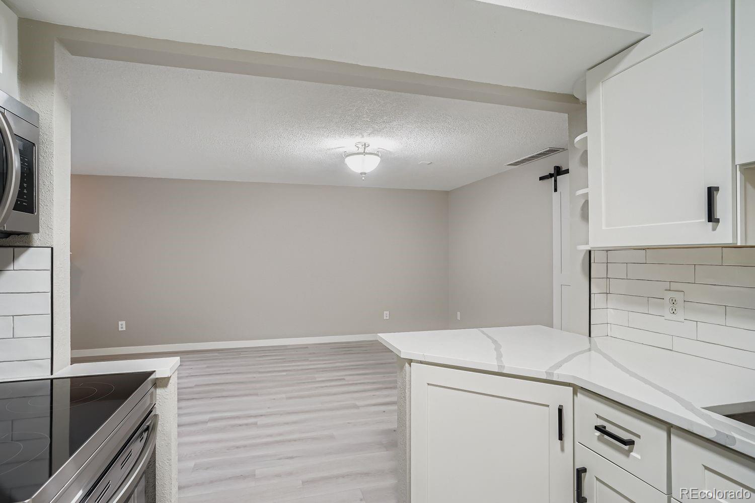 3050 West 32nd Avenue, Unit 102C Denver, CO 80211 - Photo 10 of 36 a kitchen with a sink and cabinets