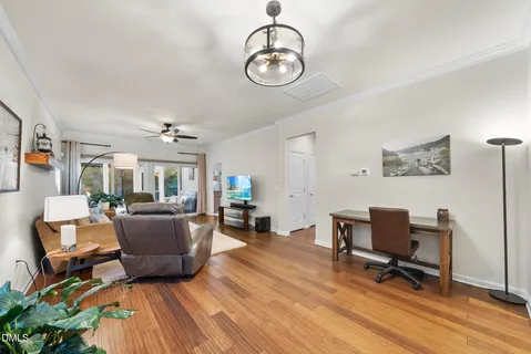 a view of a livingroom with furniture hardwood floor and a chandelier