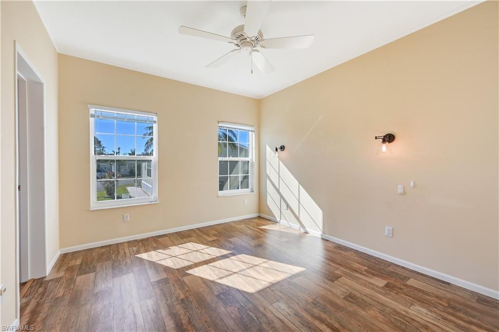 22 Enchanting Boulevard, Unit E22 Naples, FL 34112 - Photo 11 of 20 a view of an empty room with window and wooden floor