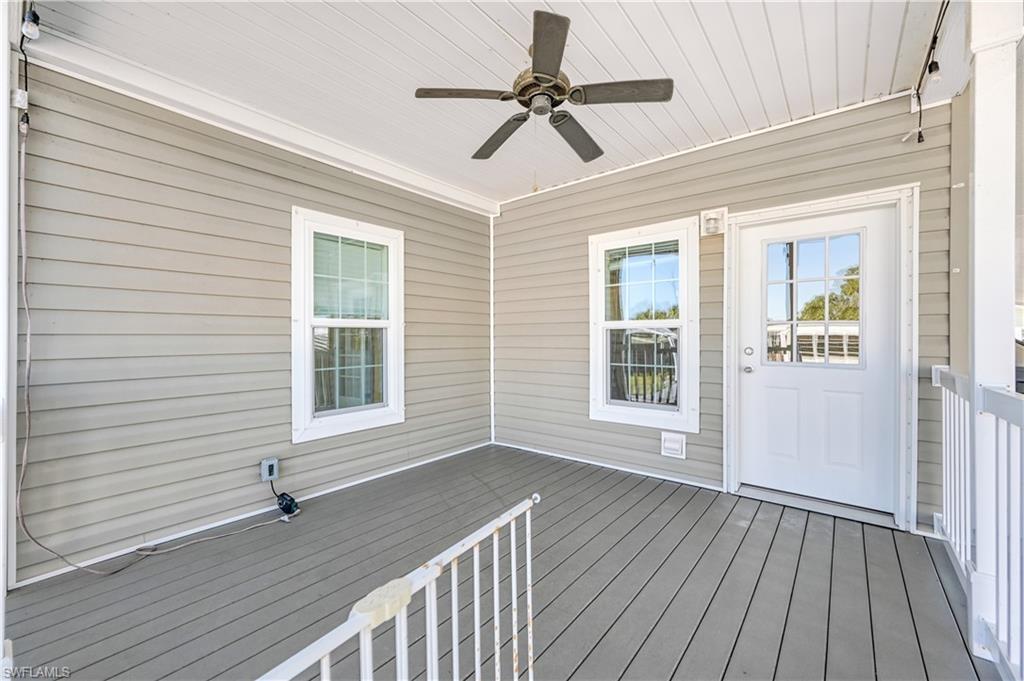 22 Enchanting Boulevard, Unit E22 Naples, FL 34112 - Photo 19 of 20 a view of an empty room with wooden floor and a window