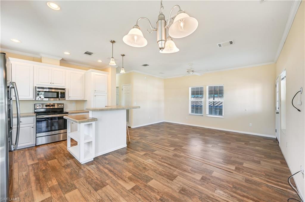 22 Enchanting Boulevard, Unit E22 Naples, FL 34112 - Photo 9 of 20 a view of kitchen with sink microwave and stove top oven