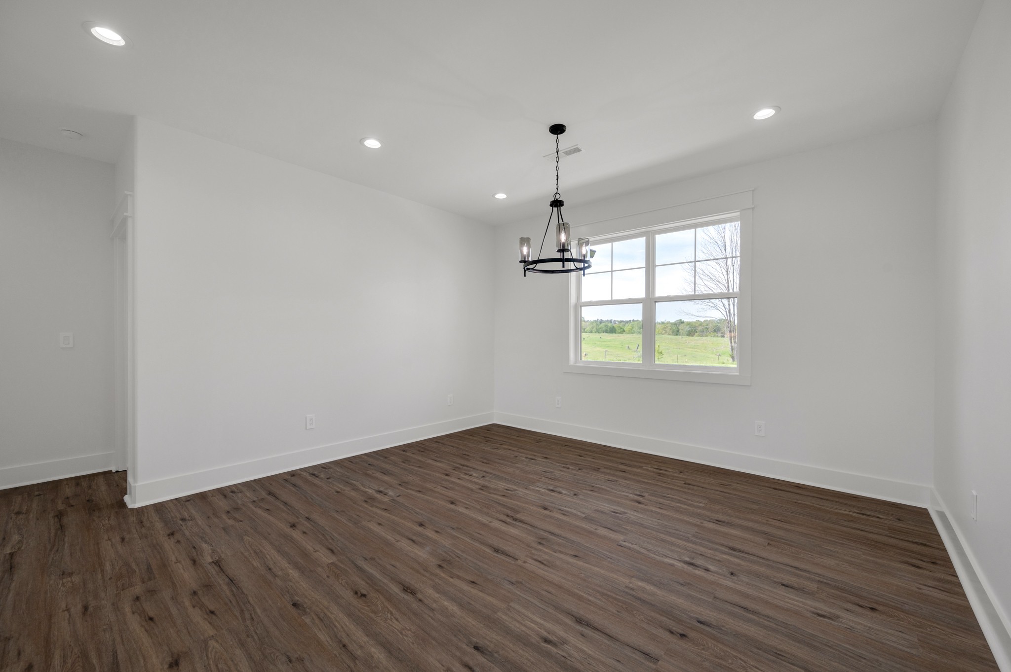 625 Robert Smith Road McMinnville, TN 37110 - Photo 22 of 40 an empty room with wooden floor and windows