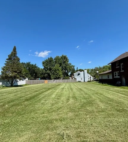 a swimming pool is in the backyard of a house