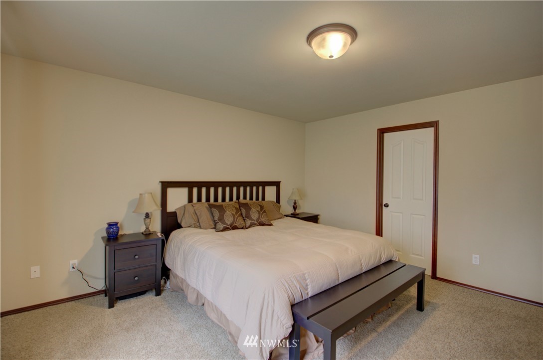 5138 180th Trail Southwest Rochester, WA 98579 - Photo 14 of 33 a large bed sitting in a bedroom next to a window