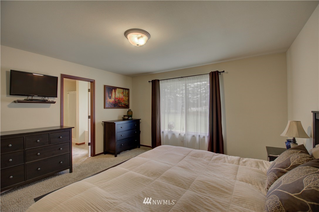 5138 180th Trail Southwest Rochester, WA 98579 - Photo 15 of 33 a bedroom with a bed and a flat screen tv