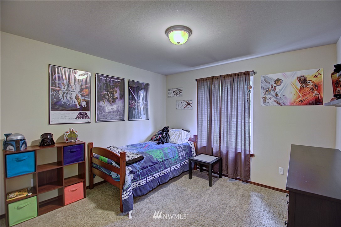 5138 180th Trail Southwest Rochester, WA 98579 - Photo 21 of 33 a bedroom with a bed and a workspace